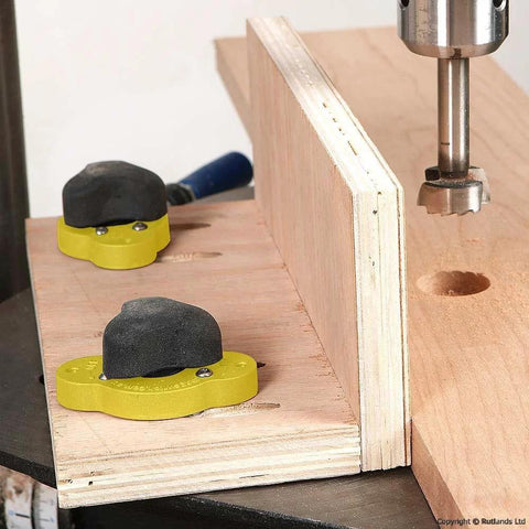 Magswitch MagJig 95 yellow magnetic base clamps with black tops on a wooden jig (two units).