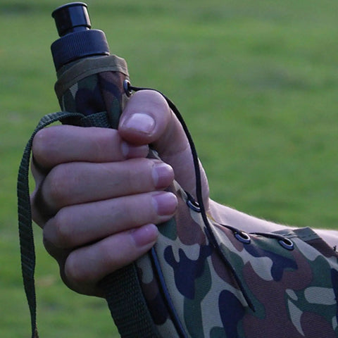 Close-up of hand holding Leakproof Outdoor Water Bottle With Rugged Oxford Cloth Carry Handle Built For Camping And Hiking