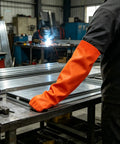 No Sweat Flame Resistant Welding Sleeves With Adjustable Cotton Fit shielding a mechanic in vivid orange during welding.