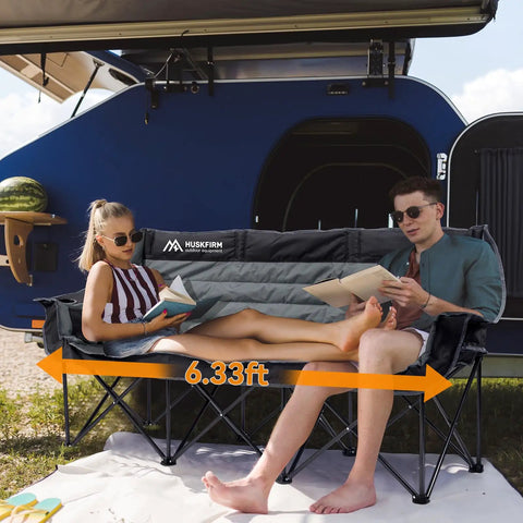 Couple relaxing on a Three Person Folding Camping Chair Couch With Padded Comfort Oversized Outdoor Loveseat Heavy Duty Frame