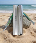 Two Pack Reflective Spearfishing Throw Flashers With Dual Tails For Trolling And Deep Drop displayed on beach sand.