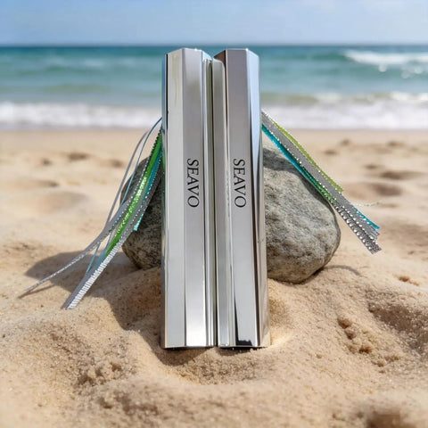 Two Pack Reflective Spearfishing Throw Flashers With Dual Tails For Trolling And Deep Drop displayed on beach sand.