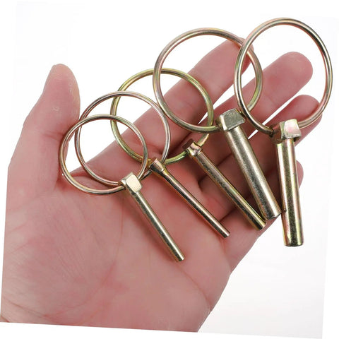 Hand holding Beefy 10 Pack Heavy Duty Lynch Pin Kit With Spring Loaded Quick Disconnect Rings for trailer hitch applications