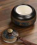 Airtight Ceramic Tea Canister With Silicone Seal Lid For Loose Leaf Coffee Beans Snacks And Nuts Keeps Kitchen Stash Crisp on a wooden tabletop.