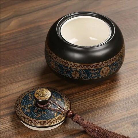 Airtight Ceramic Tea Canister With Silicone Seal Lid For Loose Leaf Coffee Beans Snacks And Nuts Keeps Kitchen Stash Crisp on a wooden tabletop.
