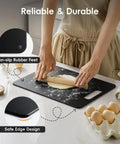 Person using black wood fiber cutting board from Wood Fiber Cutting Board Set 2 Pack For Your Kitchen Dishwasher Safe Non Toxic BPA Free Non Slip Non Porous Composite Chopping Boards For Meat Veg And Fruit Go To Kitchen Essential Easy Clean Durable with non-slip feet and dough on top.
