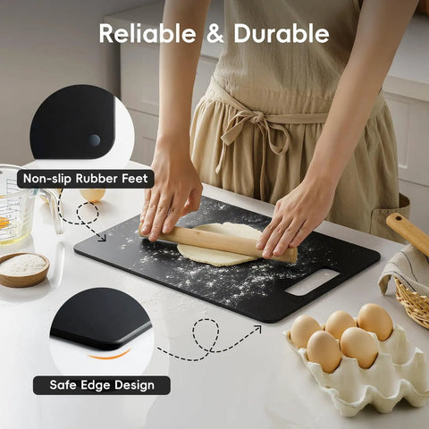 Person using black wood fiber cutting board from Wood Fiber Cutting Board Set 2 Pack For Your Kitchen Dishwasher Safe Non Toxic BPA Free Non Slip Non Porous Composite Chopping Boards For Meat Veg And Fruit Go To Kitchen Essential Easy Clean Durable with non-slip feet and dough on top.