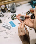 Watchmaker using 360 Piece Watch Band Pins Kit, Stainless Steel Cotter Pins, Replacement Link Pins For Watch Bands, 18 Sizes, 6 To 23mm, Assortment, Handy DIY Repair Kit For Watchmakers on a wristwatch.