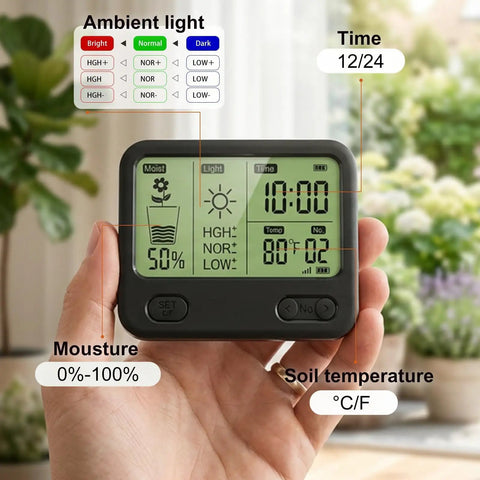 Hand holding expandable twelve zone wireless plant monitor kit with indoor LCD hub displaying soil moisture and temperature data.