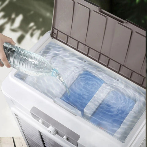 Pouring water into the tank of a Heavy Duty Portable Swamp Cooler With 750 Watt Motor And 23 Point 7 Gallon Tank for cooling.