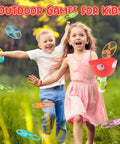 Children playing with Disc Launcher And Catcher Toy in a grassy field, smiling boy and girl enjoying outdoor fun with mini discs.