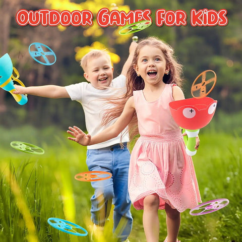 Children playing with Disc Launcher And Catcher Toy in a grassy field, smiling boy and girl enjoying outdoor fun with mini discs.