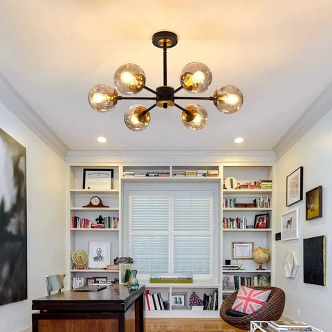 Lit Six Light Black Glass Globe Chandelier For Living Room And Kitchen Island in a modern farmhouse style office space.