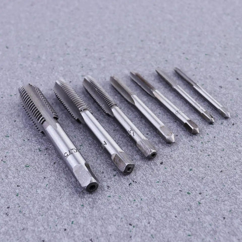 7 Piece Steel Screw Tap Set For Metalworking And DIY Projects, Heavy Duty HSS taps arranged on a gray surface