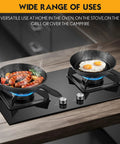 Two cast iron skillets from Three-Piece Cast Iron Skillet Set With 6 Inch, 8 Inch, And 10 Inch Pans Includes Cleaning Scraper And Dish Sponge Oven And Stovetop Safe Cookware Black Edition on stovetop cooking eggs and sausages