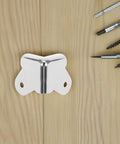 12 Pieces Metal Speaker Cabinet Corner Guards 1.57 Inch Silver Edge Protectors with screw holes on wooden surface with tools