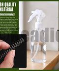 Person holding a Mini Stainless Steel Extension Spring from 100 Piece Multipack next to a spray bottle, showcasing usage.