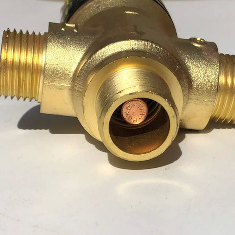 Close-up of thermostatic mixing valve with one half NPT male connections water temperature controller valve solid brass body.