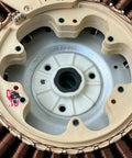 Close-up of refurbished washing machine rotor stator direct replacement assembly showing coils and mounting points.