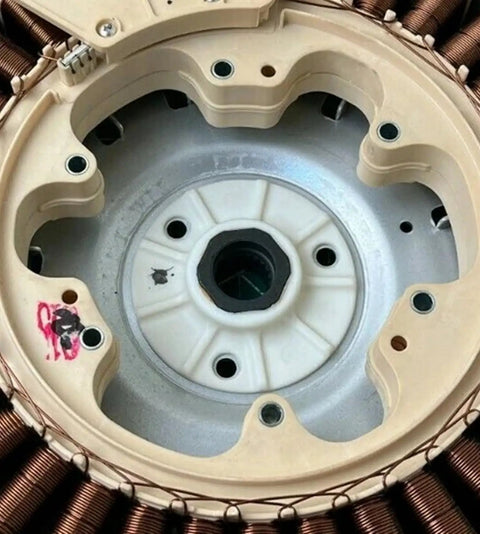 Close-up of refurbished washing machine rotor stator direct replacement assembly showing coils and mounting points.