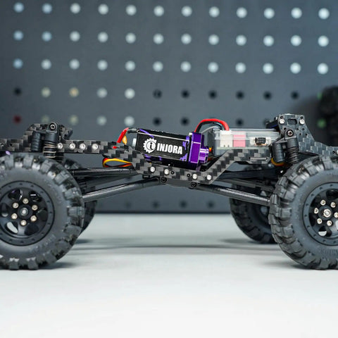 Side view of Universal Carbon Fiber LCG Chassis Kit for 1/24 Axial SCX24 with adjustable wheelbase and skid plate