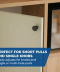 Close-up of a cabinet door with a single black knob pull, demonstrating its compatibility with various knob and pull designs.