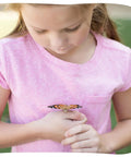 Young girl holding butterfly in Cup Of Caterpillars Refill Kit With Five Live Painted Lady Caterpillars And Food Included