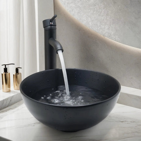 Dope Matte Black Vessel Sink Set With Faucet And Pop Up Drain, 12.8 Inch Round Ceramic Above-Counter Bathroom Sink filled with water