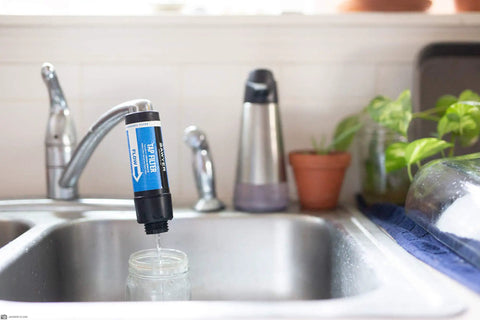 Tap Water Filtration System With 0.1 Micron Inline Filter, Fits Faucets And Hose Bibs, blue filter attached to kitchen tap