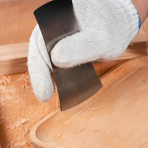 Top Shelf Six Piece Cabinet Scraper And Burnisher Kit With Blue Spring Steel Blades Plus Hardened High Speed Steel Sharpening Rod For Knockout Woodworking Finishes Daily, hand using scraper on wood.