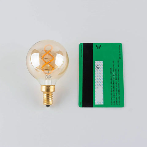 Dimmable E12 LED Filament Bulb 4W 40W Equivalent Amber 2200K 300 Lumens G16.5 next to credit card for size comparison