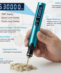 Close-up of Badass Slick Five Speed Rechargeable Mini Drill Pen with LCD display in hand, drilling into metal for precision work.