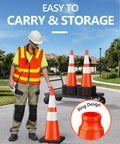 Worker holding 4 Pack 28 Inch Traffic Cones With Black Weighted Base For Traffic Control at Construction Sites and Parking Lots