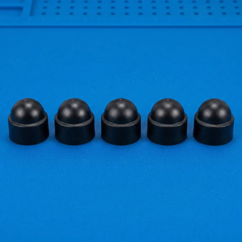Five M8 black plastic hex dome nut caps on blue surface, part of a 50 Pack M8 Black Plastic Hex Dome Nut Caps Protective Screw Covers for Exposed Ends.