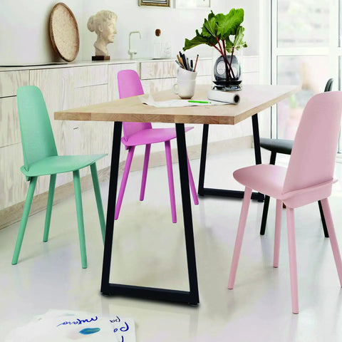 Dining area with trapezoid design 36 inch metal table bar legs heavy duty beefy industrial style supporting wooden top with pastel chairs