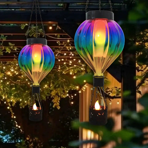 Hot Air Balloon Solar Lantern Outdoor Waterproof Hanging Glass Light With Flickering Flame Totally For Garden Backyard Patio Fence Decor Purple Gifts For Women, illuminated against trees and pergola at night