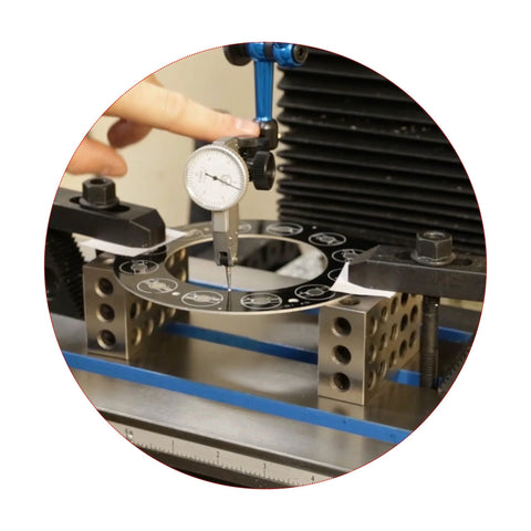Front view of HFS 1-2-3 machinist blocks with a circular 23-hole ring, dial indicator measuring setup on metal base