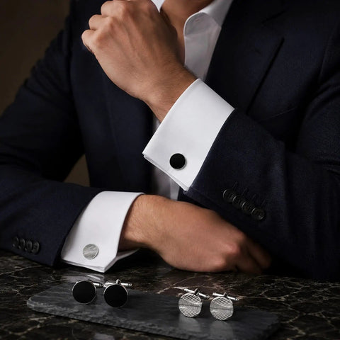 Two Pair Silver Plated French Cufflinks For Men highlighting smooth black enamel disks and crisp grid mesh patterns worn with a suit.