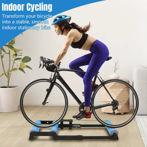 Cyclist using Whisper Quiet Indoor Bike Trainer With Foldable Stand For Road And Mountain Bikes in home gym setting
