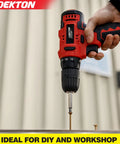 Red and black Dekton power drill driving a screw into wood, suitable for DIY and workshop projects.