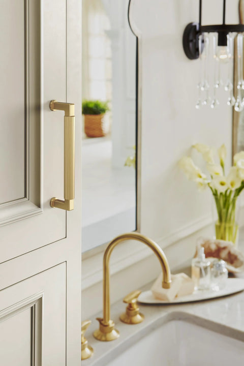 Transitional Champagne Bronze Cabinet Pull, 5-1/16 Inch Center-To-Center, installed on kitchen cabinet near sink, Model BP37644CZ