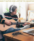 Person playing guitar connected to Six Channel Portable Mini Audio Mixer With 6.35mm To 3.5mm Adapters for laptop recording