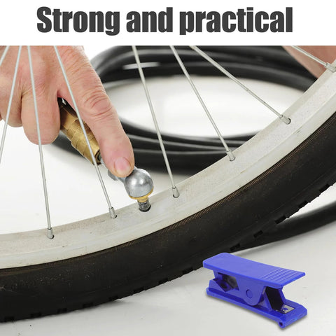 Close-up of TEHAUX bike hydraulic brake hose cutter tool on a bicycle wheel; blue plastic clip in foreground