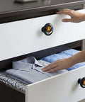 4 Pack Dope Sun And Moon Celestial Cabinet Knobs on white dresser with blue towel and striped shirt visible in drawer