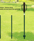 Beefy Heavy Duty Fence Post Driver With Two Handles Steel Head 16.8 Inch T Post Rammer Brown Post Pounder in action on a field.