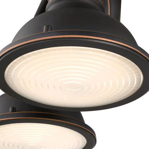 Close-up of vintage style three-light indoor vanity light fixture in oil rubbed bronze with frosted prismatic acrylic lens
