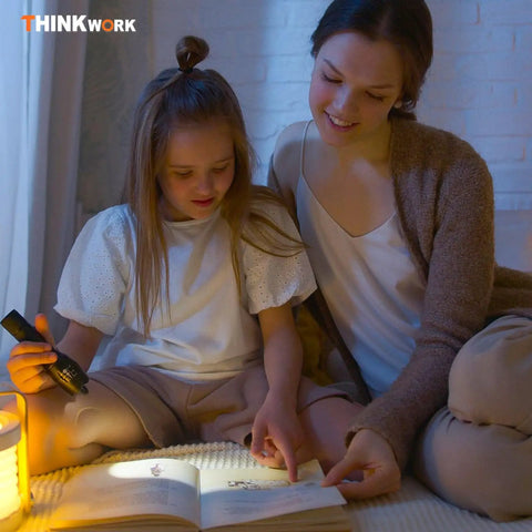 Mother and daughter reading a book by flashlight, sitting on a bed at night, cozy indoor family moment.