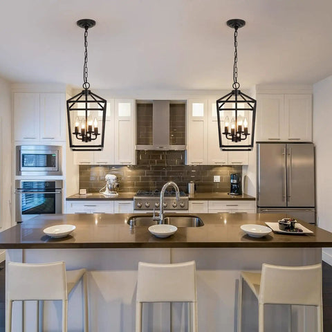 Four Light Black Farmhouse Pendant Lantern Cage Hanging Light Fixture over modern kitchen island with white cabinets