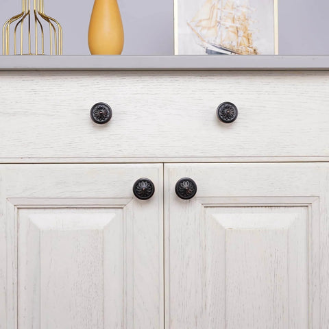 Oil Rubbed Bronze Flower Shaped Cabinet Knob Set 12 Pack For Cabinets And Drawers installed on a white double door cabinet