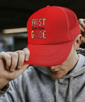 Too Cool For 1st Grade Baseball Hat For Women Vintage Red Trucker Cap With Front Artwork worn by person outdoors
